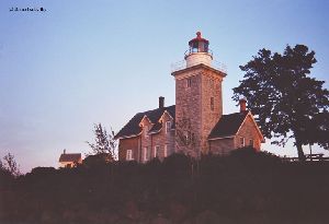 The sun sets on the lighthouse.