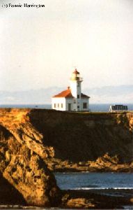 Closer shot of the lighthouse and cliffs.