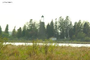 The lighthouse sits on an island.