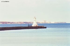 Distance shot of the lighthouse out on the pier.