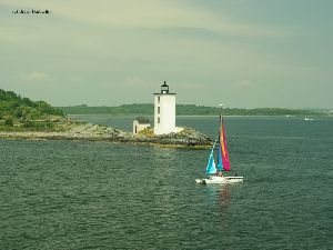 A sailboat by the tower.
