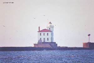Distance shot of lighthouse on breakwater.