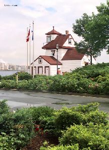 The lighthouse sits in a park.
