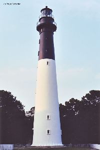 The lighthouse against a blue sky.