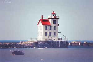 Lighthouse with boat in foreground.