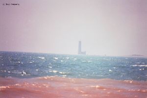 Distance shot of lighthouse out in lake.