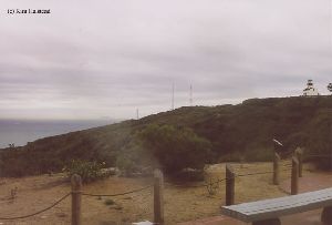 Distance shot of the lighthouse off on a hill.