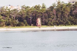 Lighthouse with trees in the background.