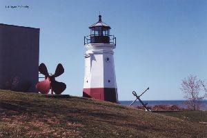 Lighthouse with propeller and anchor.