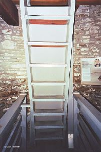 The ladder reaching up into the lantern room.
